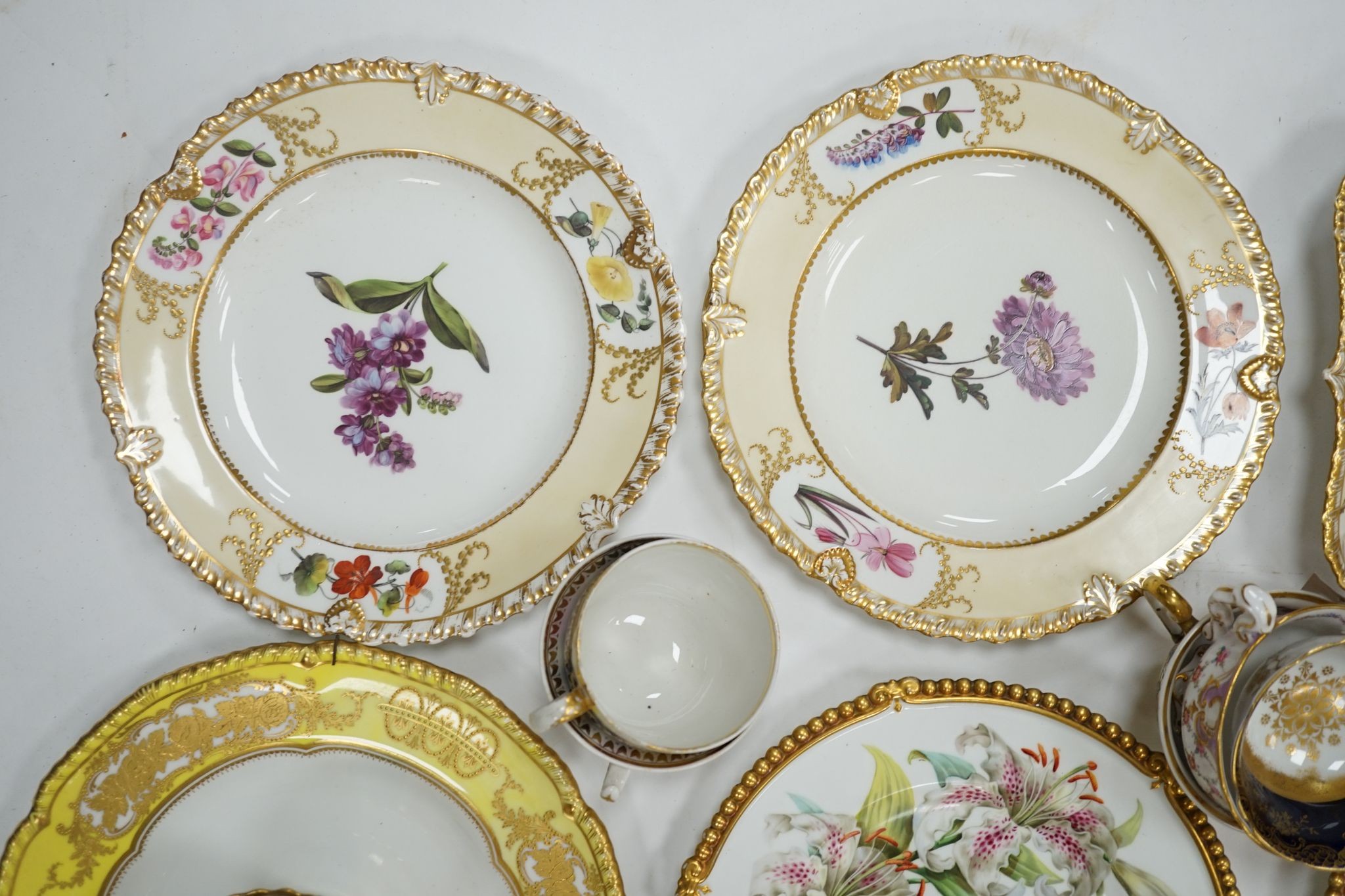 A small collection of Victorian porcelain tea cups and saucers and sundry dessert plates